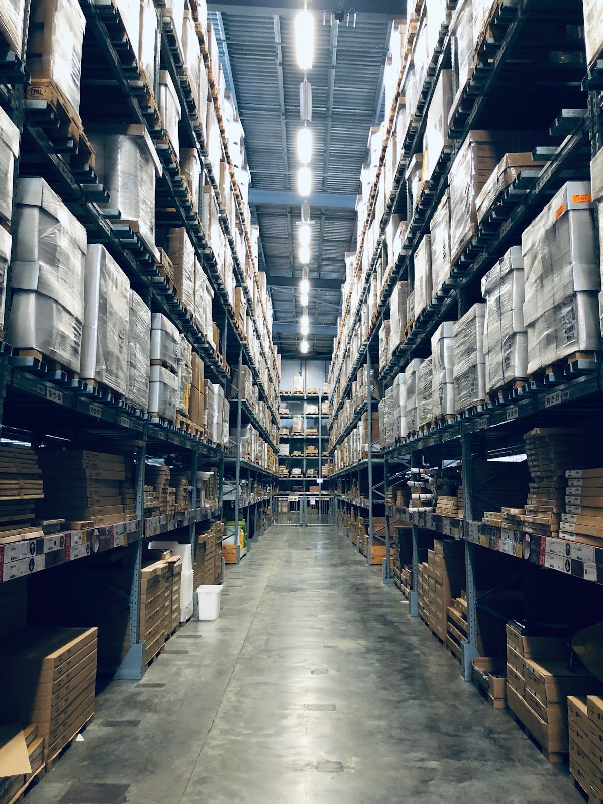 Shrink-wrapped pallets of stock on warehouse racking