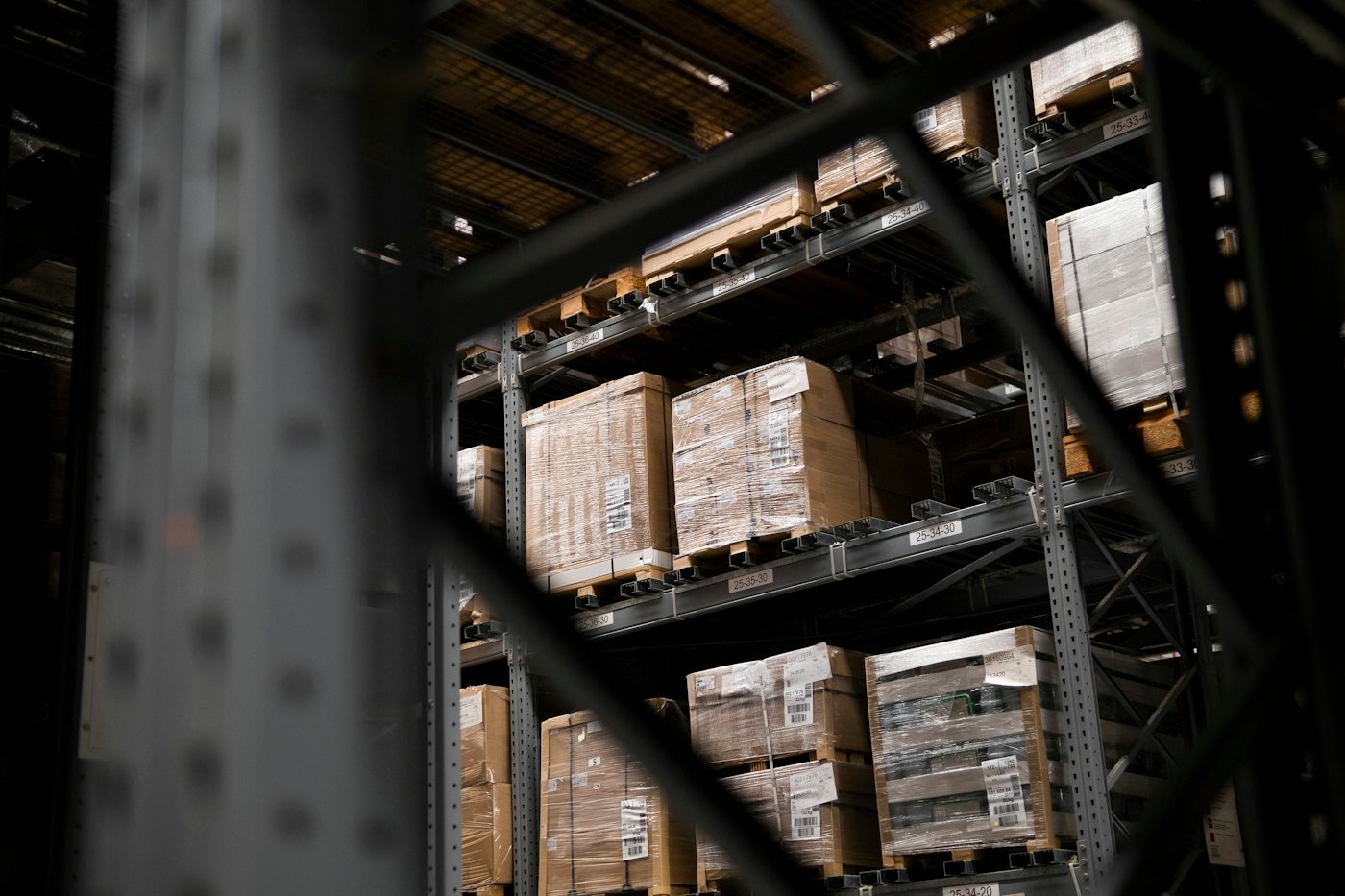 A forklift working between racks of stock